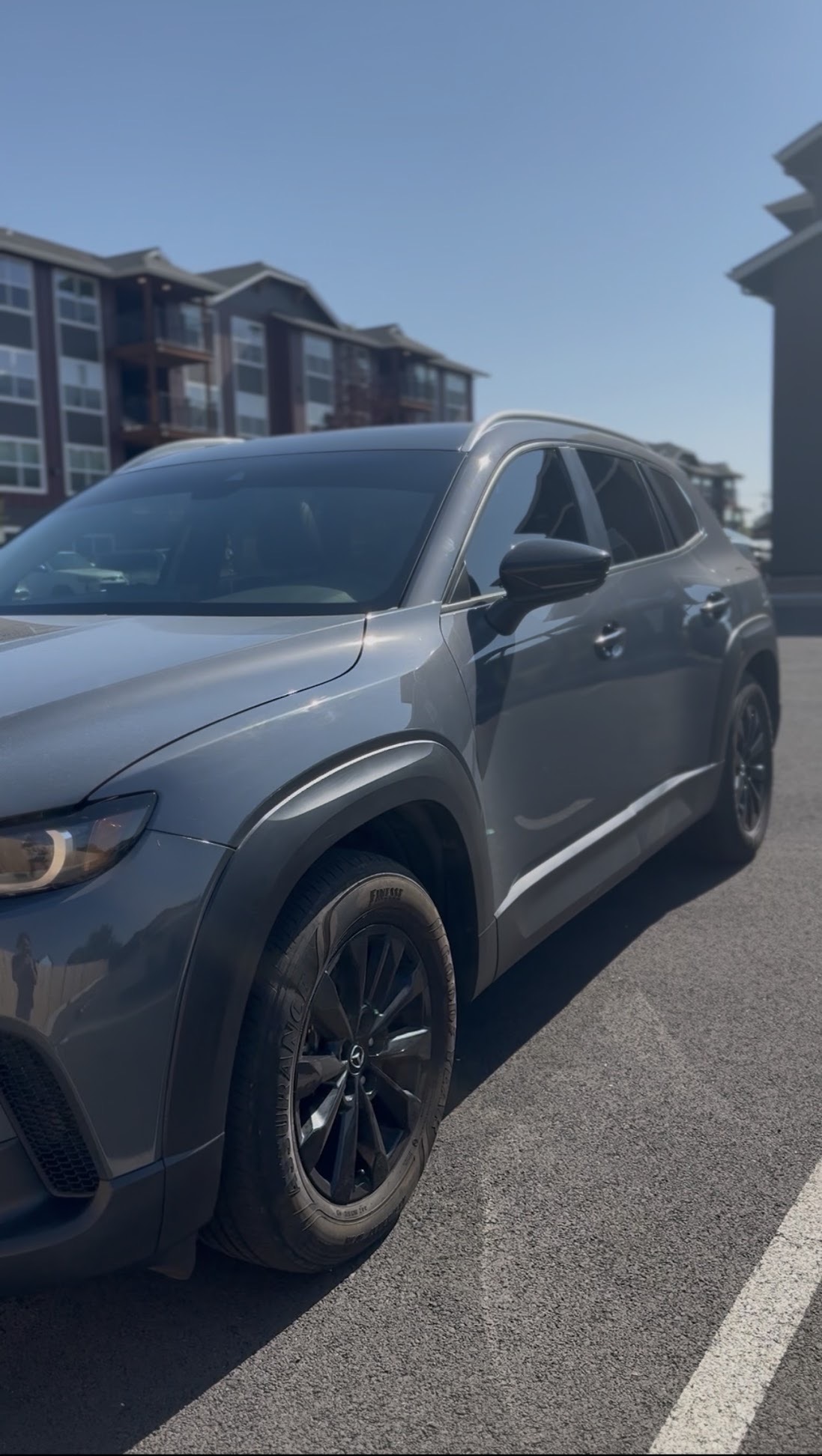 Gray Mazda CX-50 SUV with dark ceramic tint on all side windows, tinted in Central Oregon